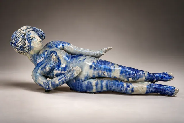 Reclining figure glazed in cobalt blue and white