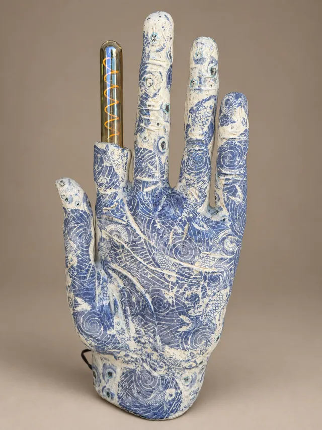 Blue-and-white patterned hand lamp with a glass bulb