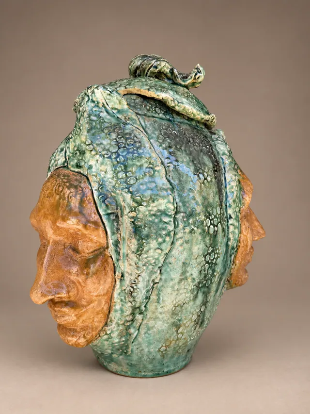 Green lidded vessel with an amber face