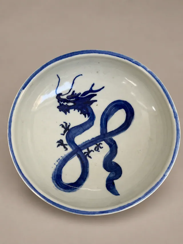 Shallow bowl with a cobalt blue dragon