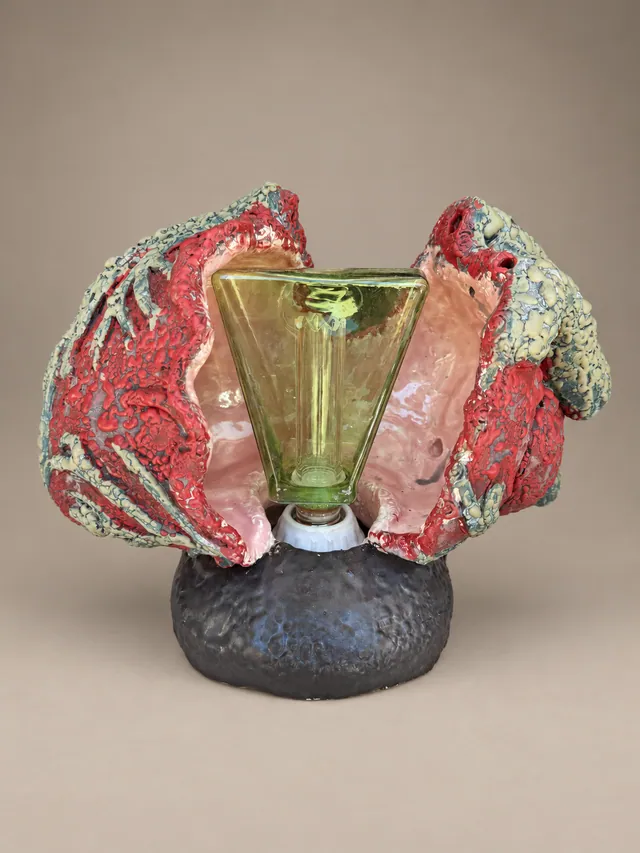 Red heart lamp with a green glass shade on a dark base