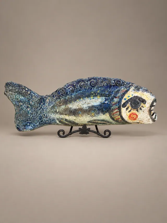 Blue fish sculpture on a stand