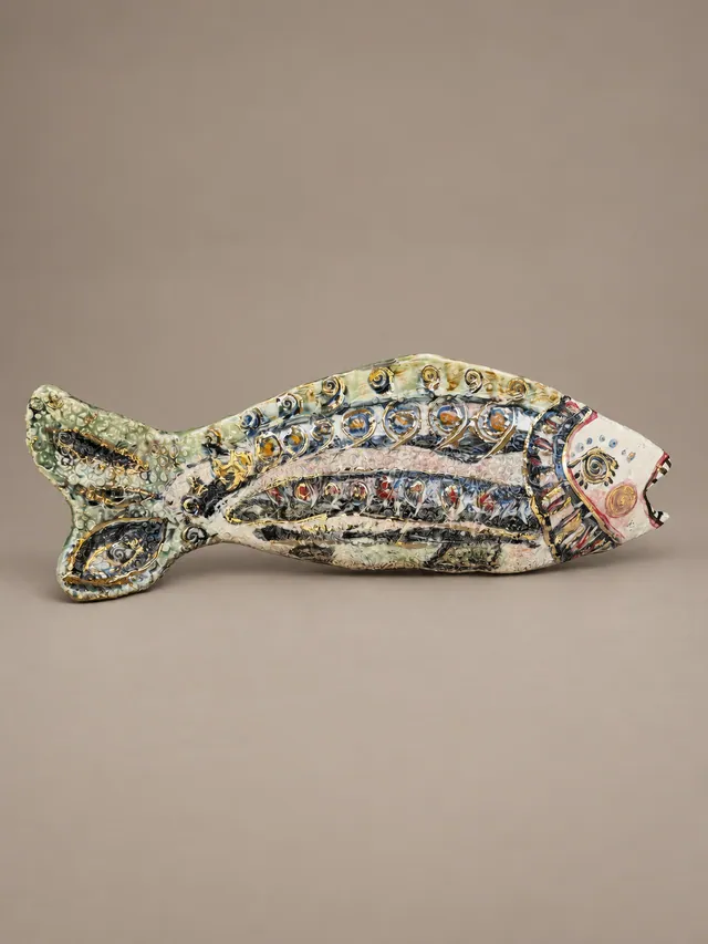 Green fish sculpture with patterned scales