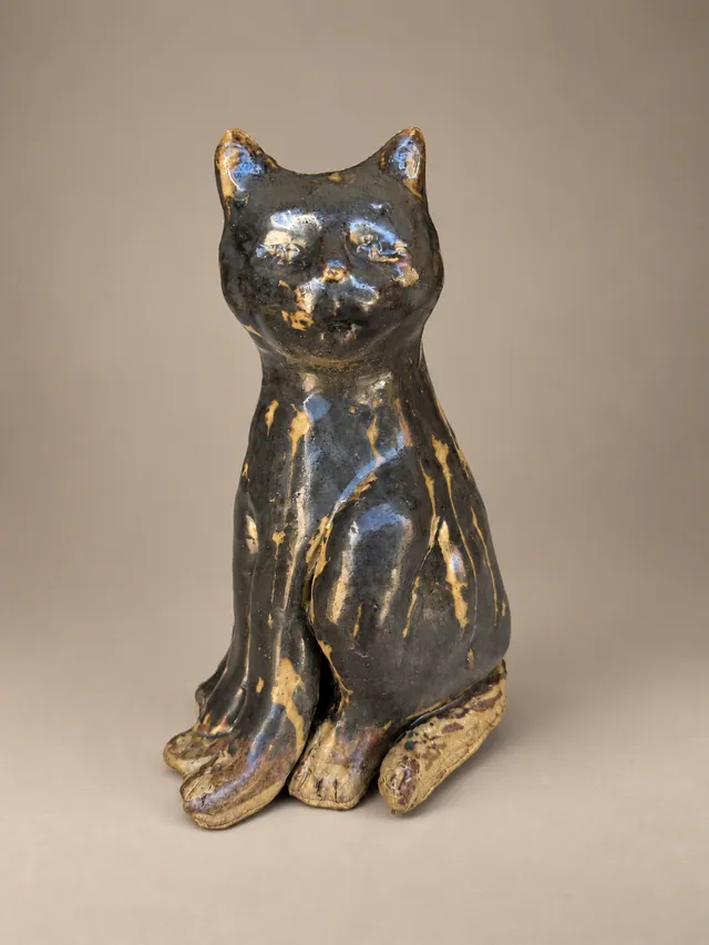 Seated dark glazed cat